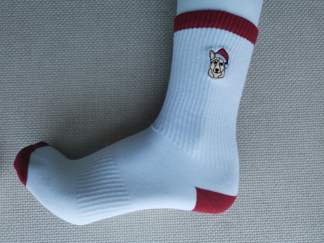 dog face embroidered logo on custom socks. half terry sole and arc support