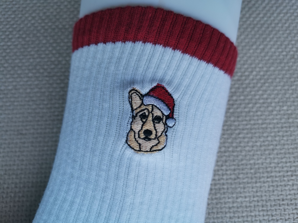 dog face embroidered logo on custom socks. half terry sole and arc support. embroidery close view