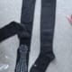 Black graduated compression knee-high sports socks with mesh upper, logo detail, and silicone grip on sole and inner cuff