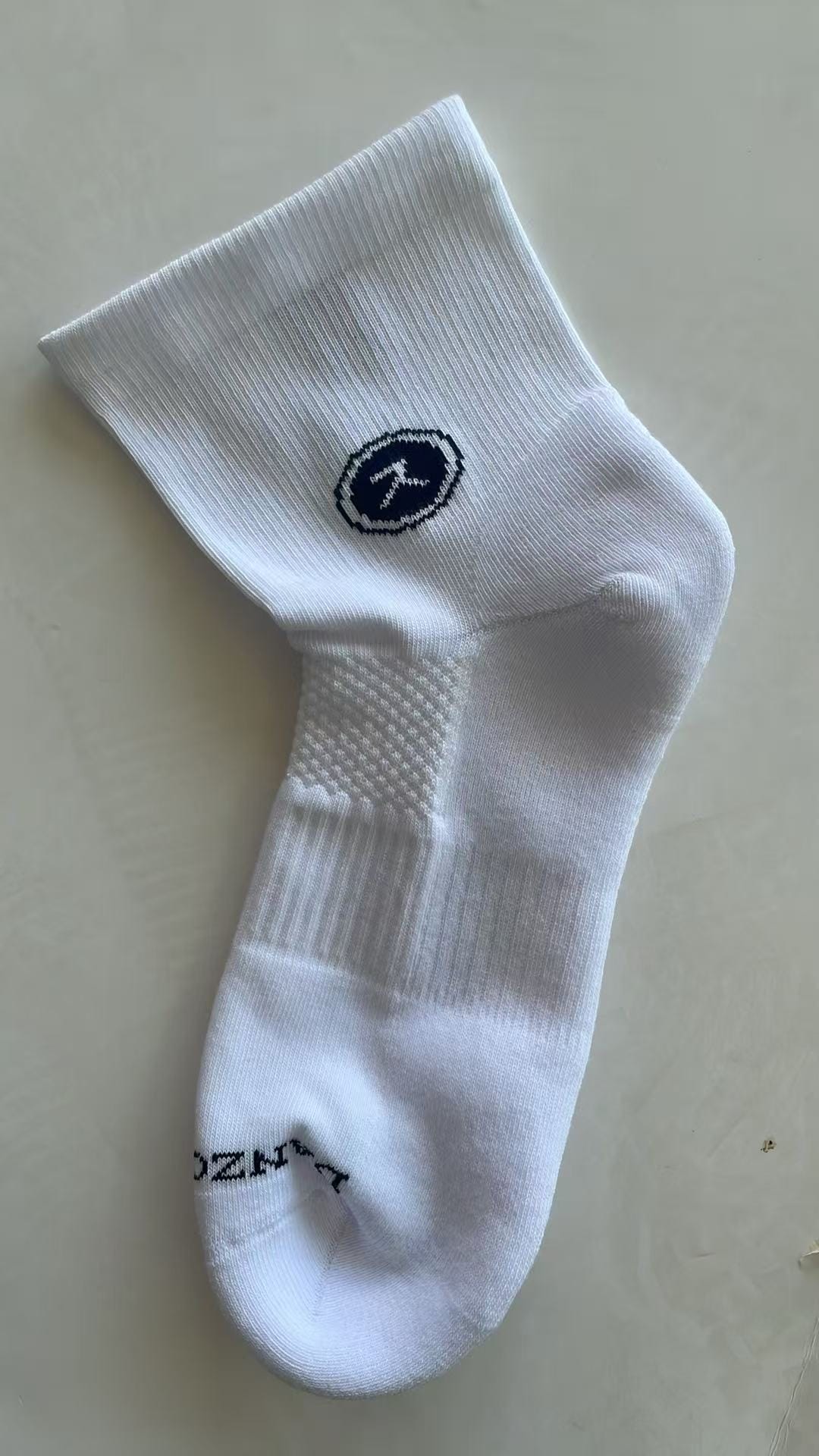 White short graduated compression sports socks with diamond mesh, arch compression and random terry cushioned sole